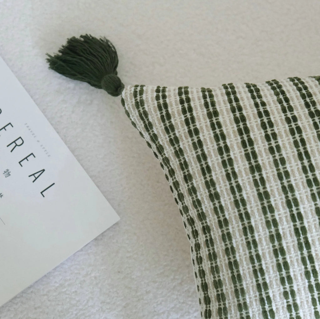 Green cotton and linen hotel sample pillow with botanical pattern and tassel trim, shown with separate pillow core.