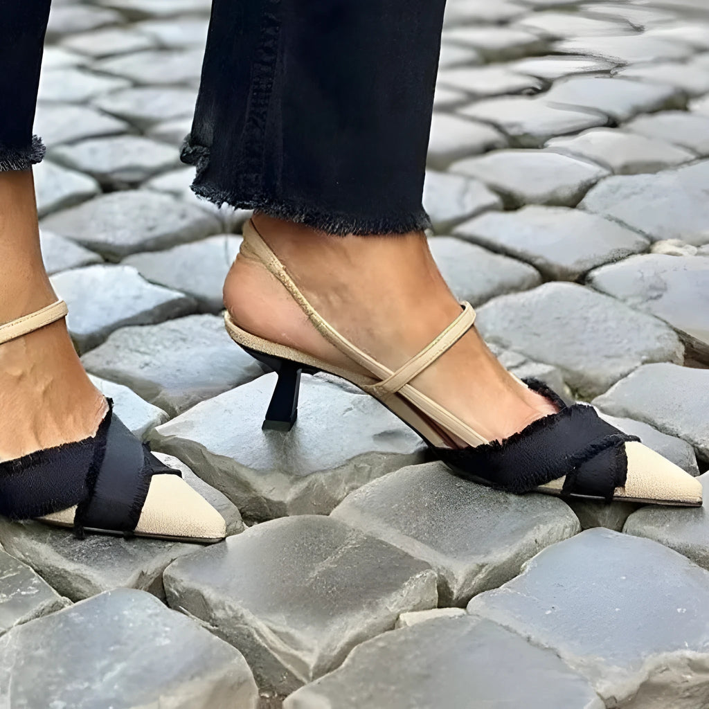 Women's apricot and black colour block stiletto heel sandals with pointed toe and ankle buckle.