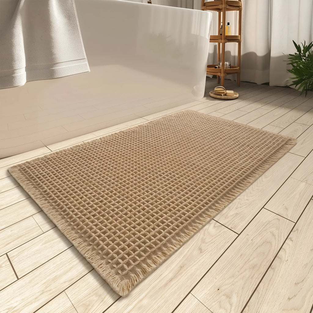 Checkered pattern non-slip polyester bathroom mat in beige colour on tiled floor.
