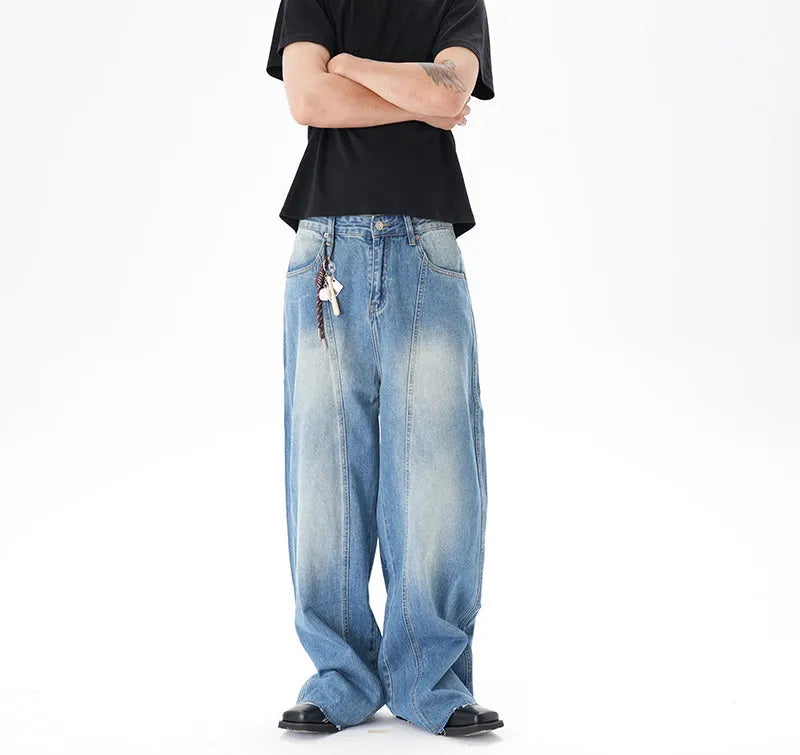 Light blue wide leg machete jeans with vintage washed denim finish, zip-fly closure, cut wash effect