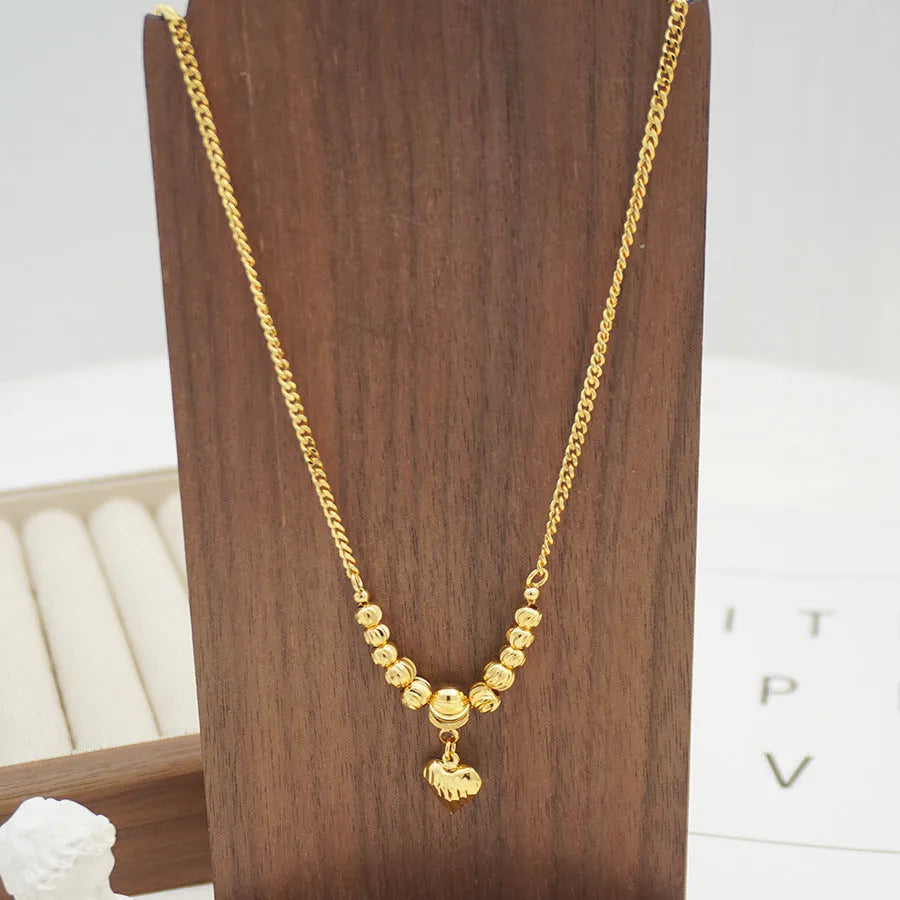 Copper geometric heart pendant necklace with electroplated finish on white background