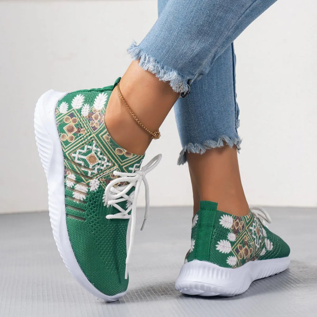 Women's woven flat shoes in green with printed totem detail, mesh upper, rubber sole, and front lace-up closure