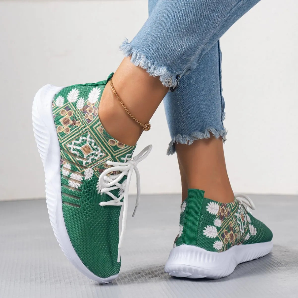 Women's woven flat shoes in green with printed totem detail, mesh upper, rubber sole, and front lace-up closure