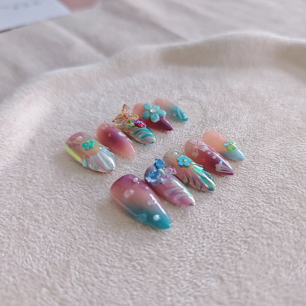 Handmade colourful nail sculptures with floral patterns and embossed butterfly designs