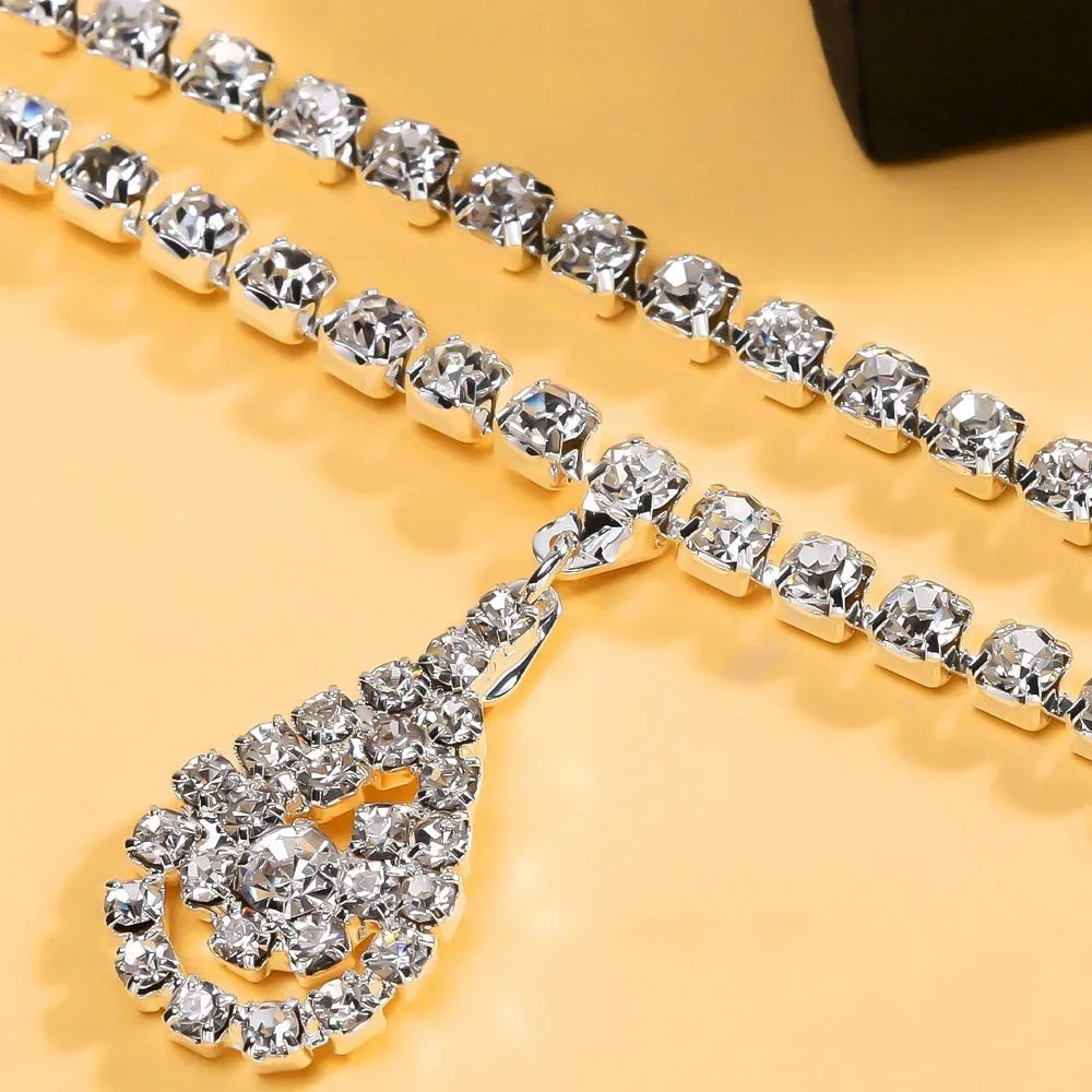 Gold water drop pendant waist chain with sparkling rhinestone tassel and lobster buckle.