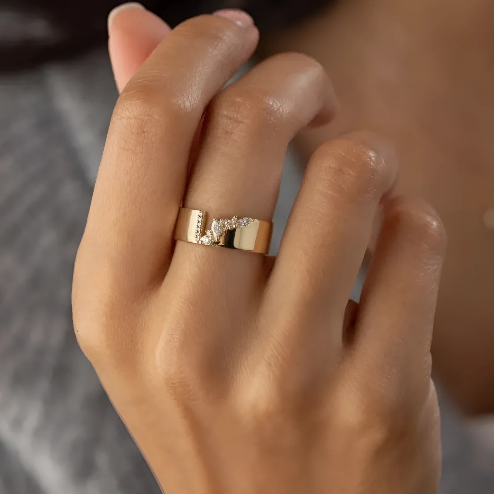 Gold electroplated women's ring with a shining zircon stone on a copper band.