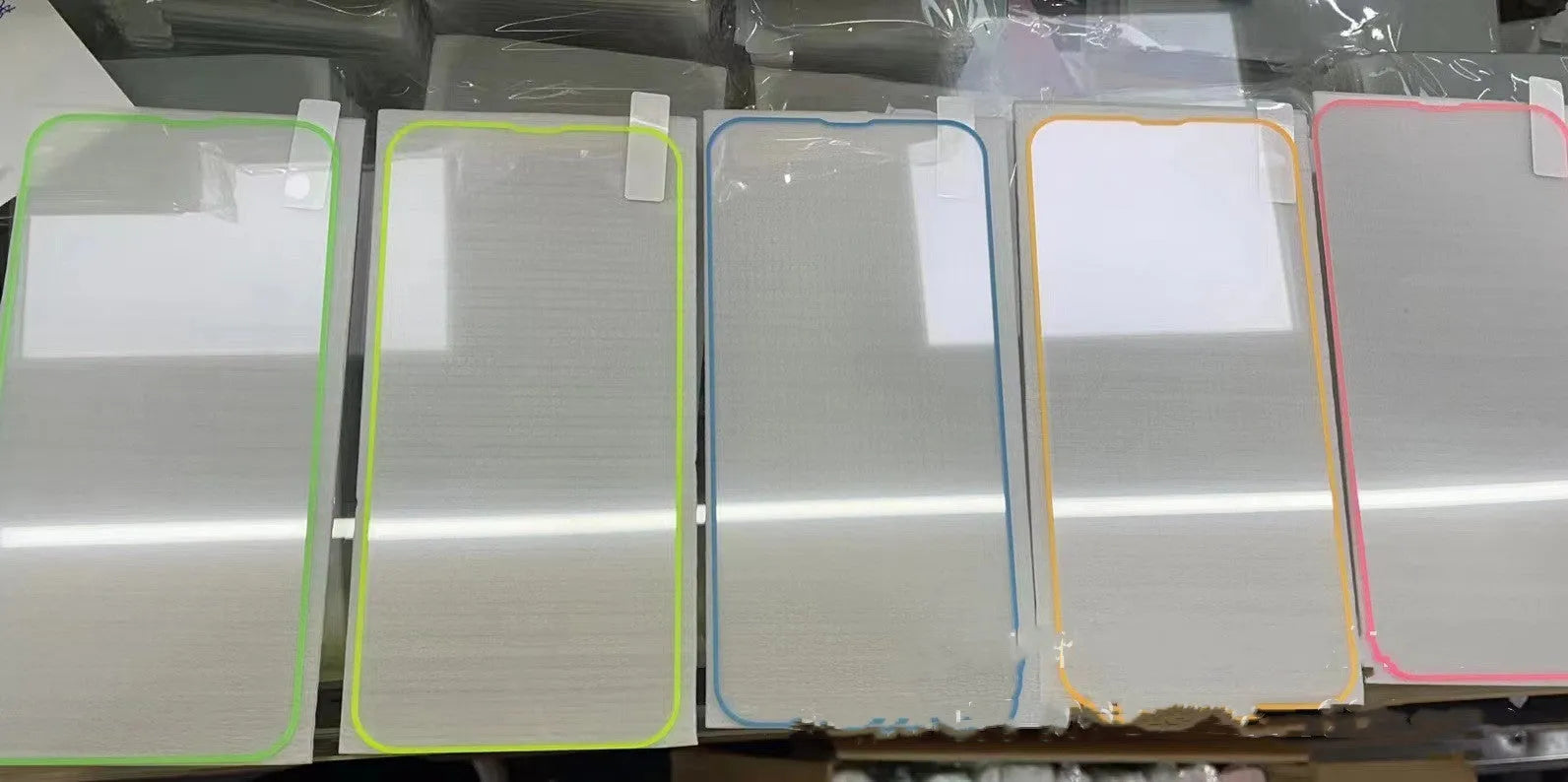 Fluorescent tempered glass screen protector for iPhone showing pink yellow green blue grass green colour options