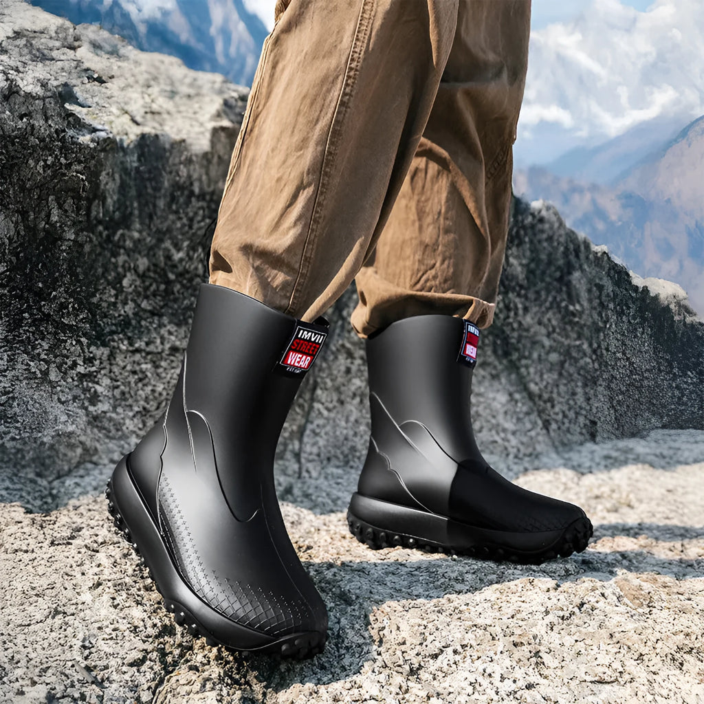 Men's mid low tube rain boots with non-slip sole and PVC upper in black
