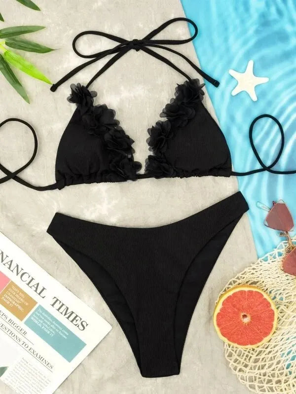 Black gathered polyester two-piece women's swimwear set with top and shorts on a model