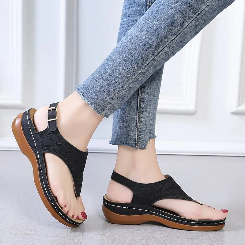 Women's casual wedge heel sandals in black with an adjustable back strap buckle.