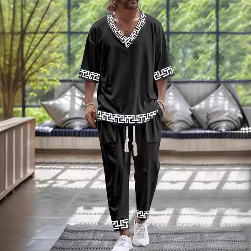 Man wearing a thin V-neck cropped sleeve jacket and matching trousers from the polyester suit set.