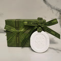 Car aromatherapy stone pendant hanging from rearview mirror with gardenia fragrance option