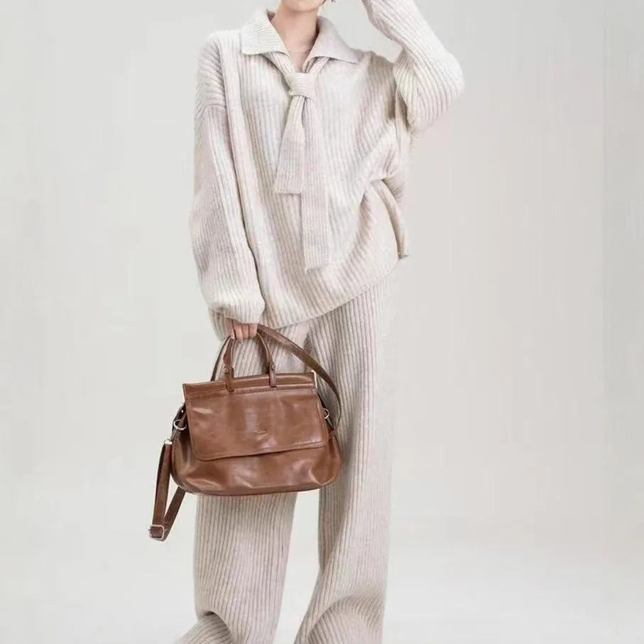 Women's beige imitation cashmere knitted sweater top and matching trousers two-piece set.