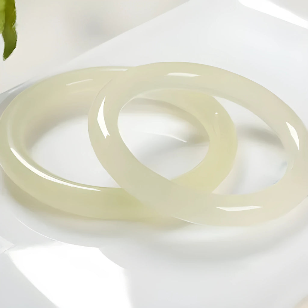 Ice-like silk jade round bar bracelet on neutral background showing smooth surface and circular shape