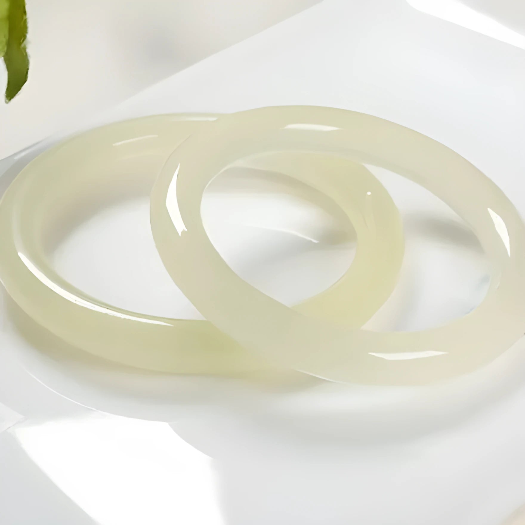 Ice-like silk jade round bar bracelet on neutral background showing smooth surface and circular shape
