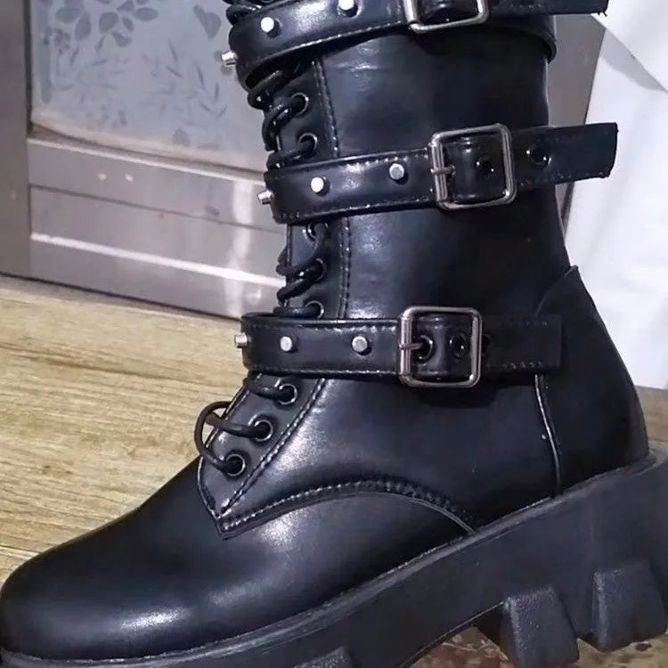 Women's black knee-high boots with metal buckle straps and a side zipper closure.
