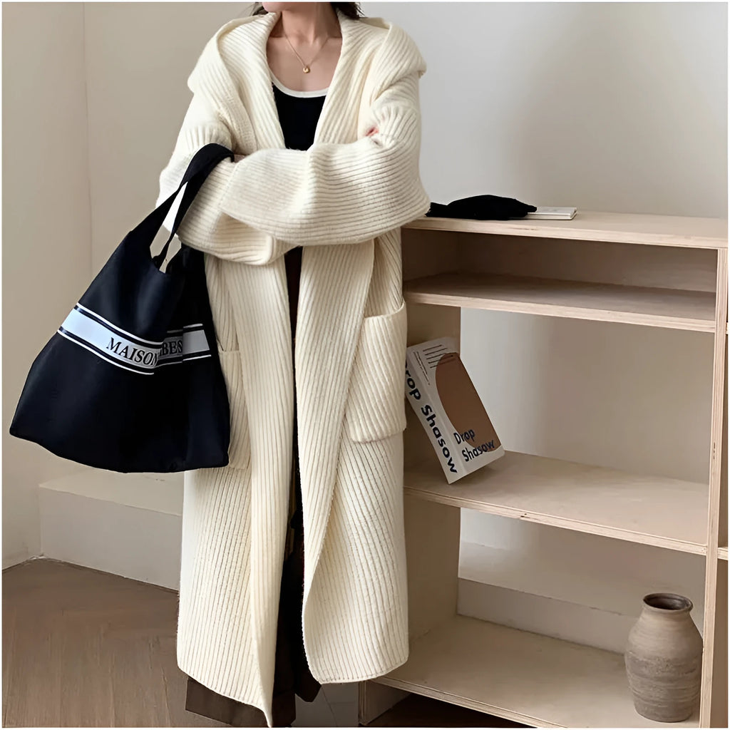 Women's loose grey hooded cardigan coat with raglan sleeves on a hanger