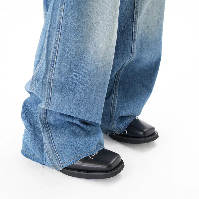 Light blue wide leg machete jeans with vintage washed denim finish, zip-fly closure, cut wash effect