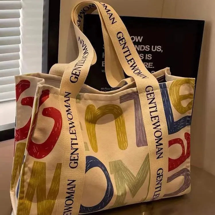 Canvas women's travel tote shopping bag in large capacity format with printing elements