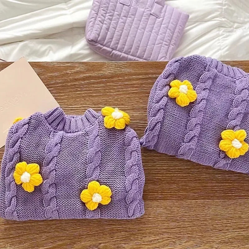 Purple knitted flower print dog coat on a pet showing pull-on style