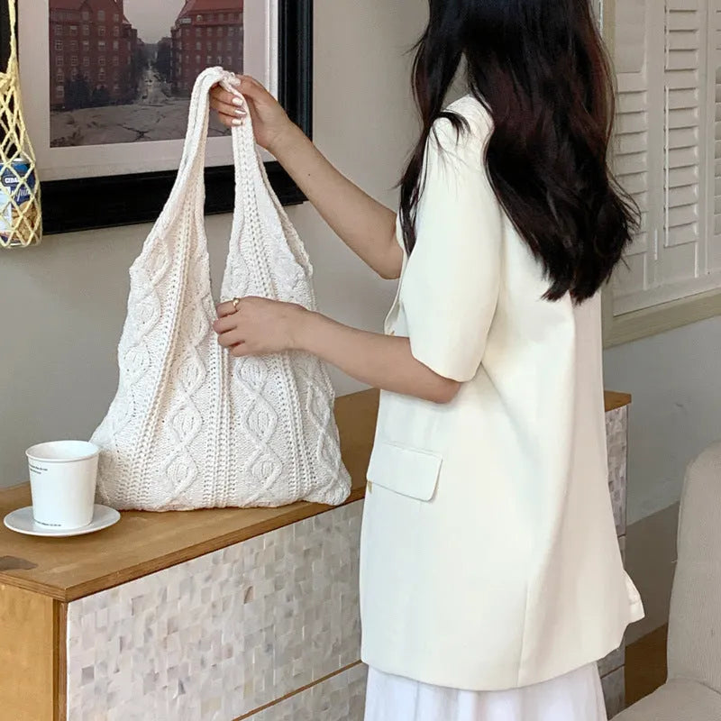 Retro hollow knitted wool yarn women's shoulder tote bag in solid colour showing double straps.