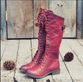 Women's black chunky heel high leg boot with round toe and low stout heel on a solid background.