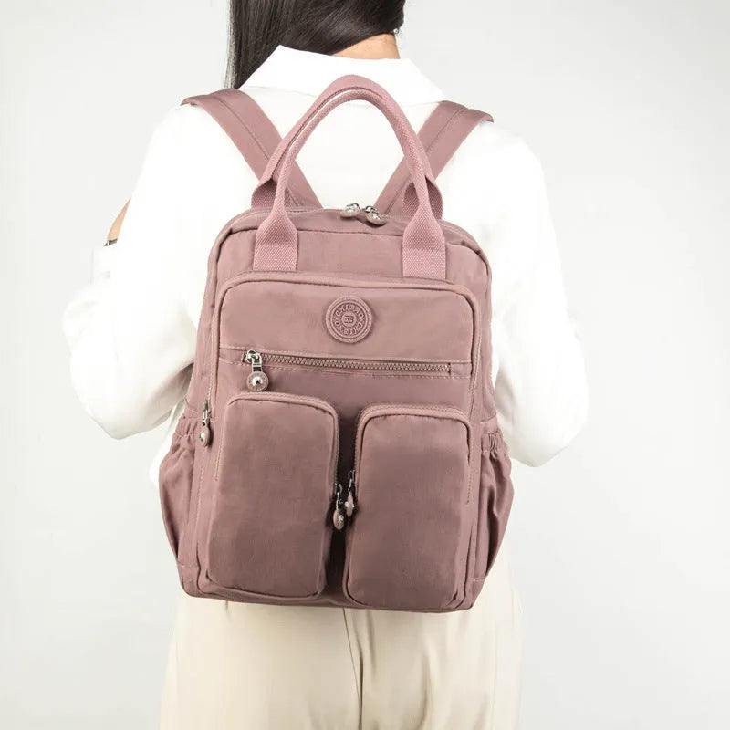 Waterproof travel backpack for women, large capacity, nylon material, multiple pockets, colour options