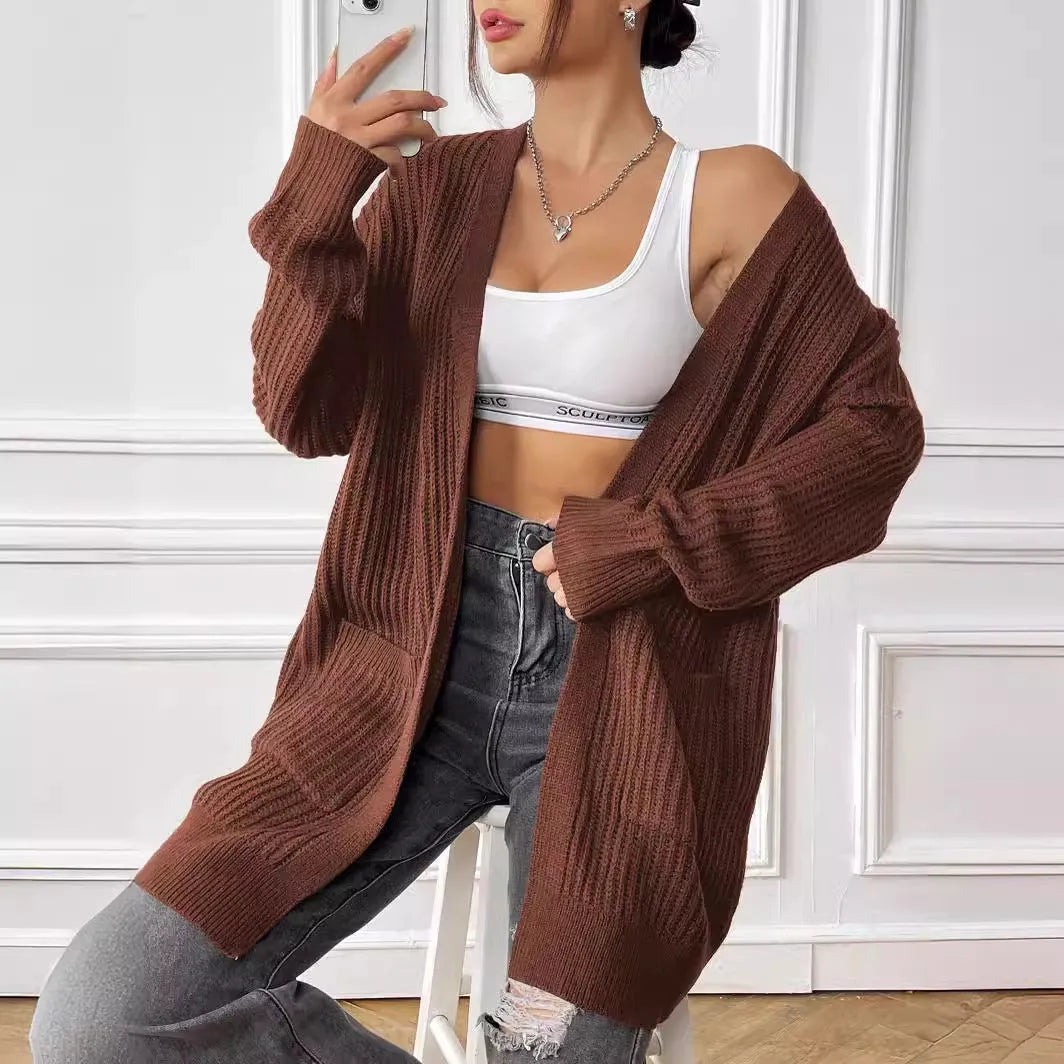 Women's dark green acrylic cardigan with two pockets and long sleeves.