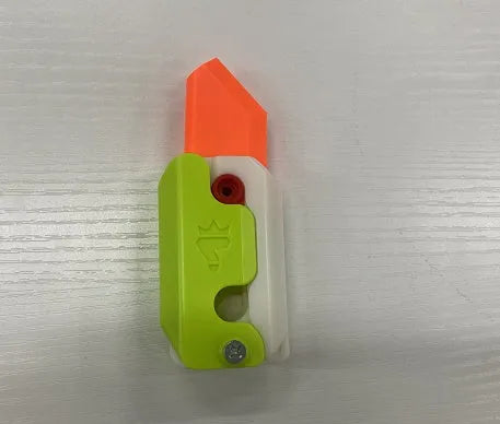 3D printed gravity carrot fidget knife in orange, purple and green colour on white background