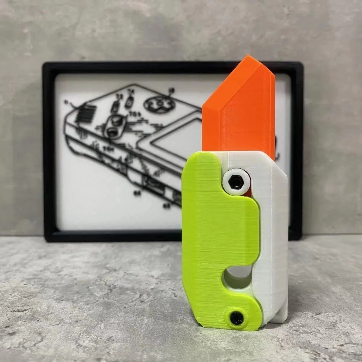 3D printed gravity carrot fidget knife in orange, purple and green colour on white background