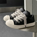 Men's black leather slip-on casual shoes with raised bottom board and round toe, side view