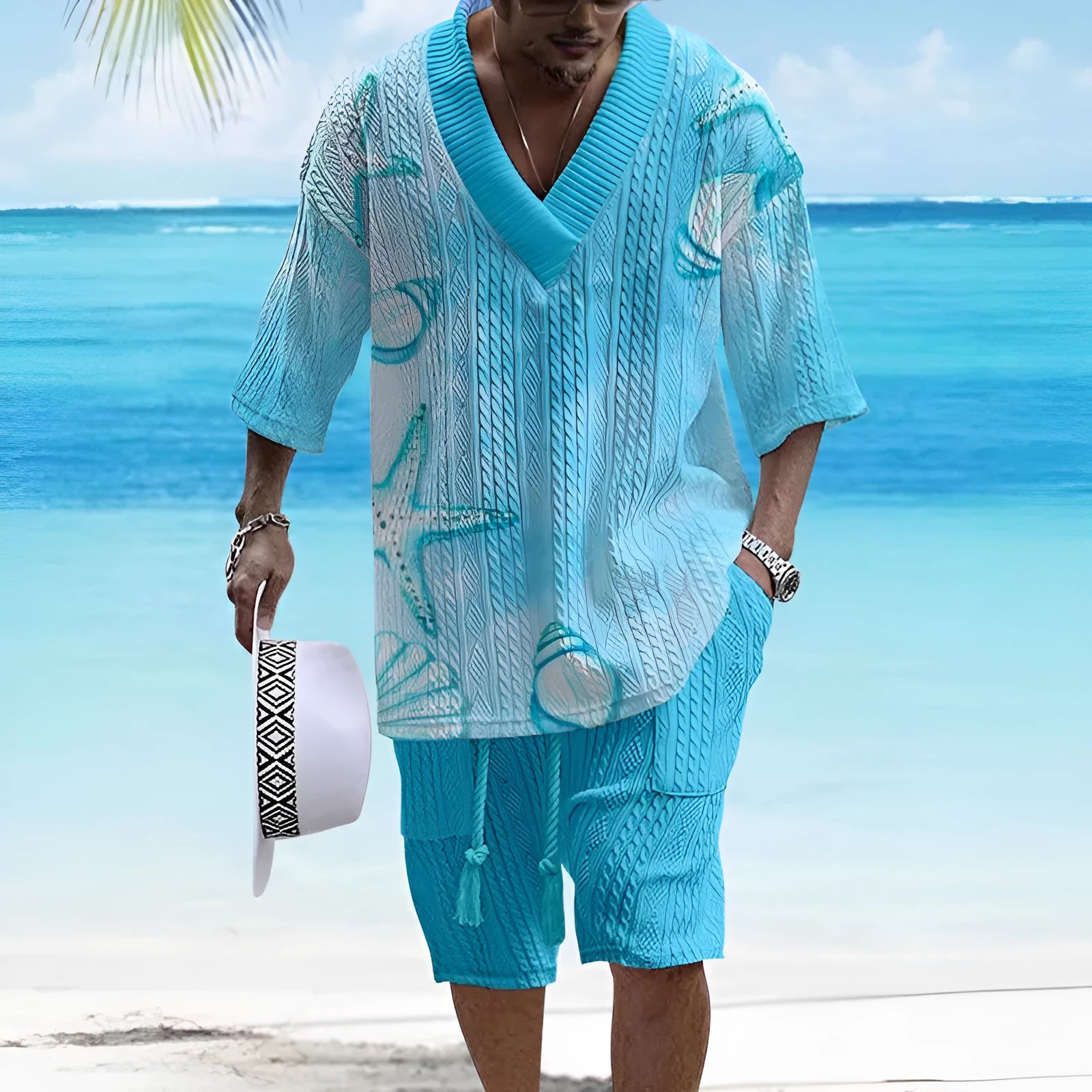 A man wearing a loose-fitting light blue short sleeve casual suit with matching shorts.