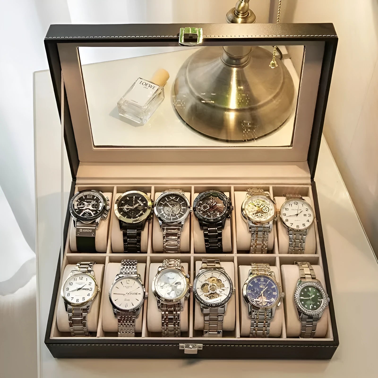 Grey leather watch storage box with clear dustproof lid showing interior watch compartments