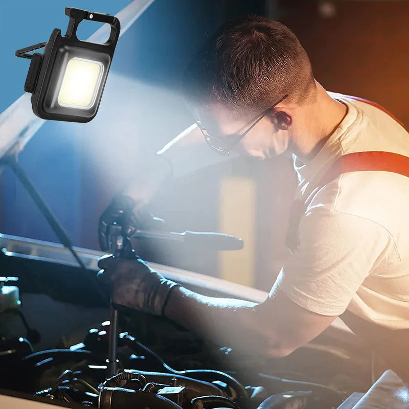 Black aluminium alloy COB keychain light with magnetic base, foldable handle, and key ring, 6x4.2cm