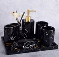 Four-piece ceramic bathroom set with bright glaze finish including bottle, cup, toothbrush holder, and soap dish