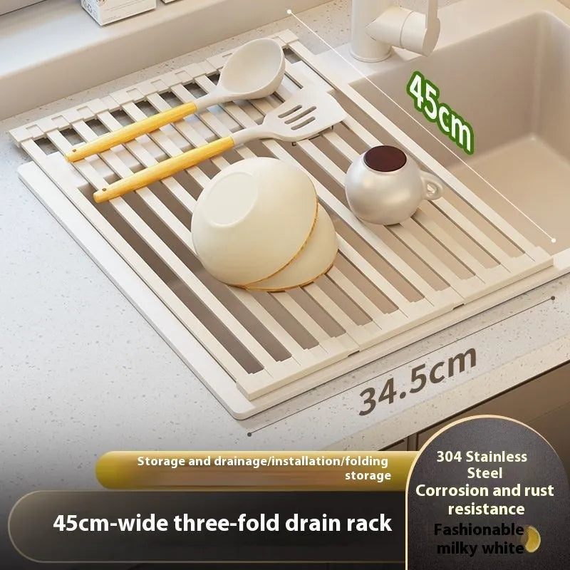 Milky white foldable stainless steel kitchen draining rack placed next to a sink.