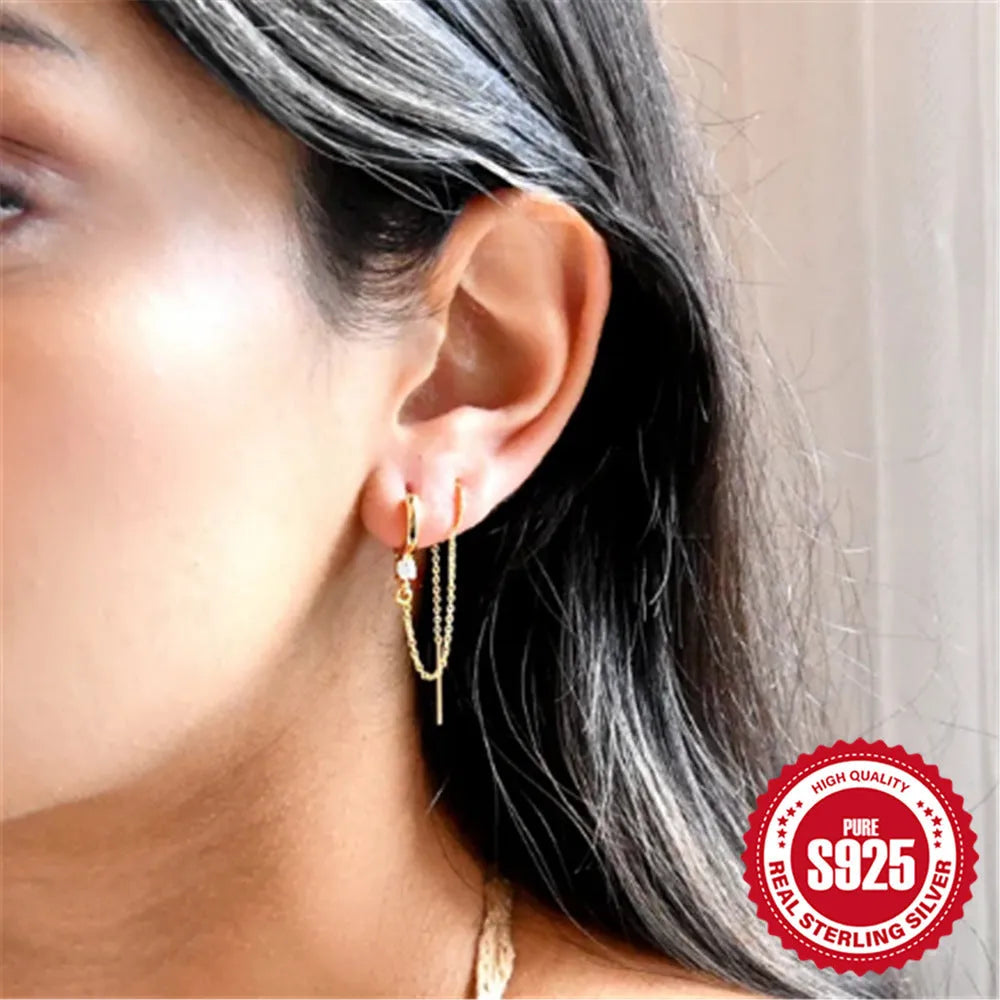 Golden tone sterling silver ear clip studs with a geometric flower, tassel, and chain design.