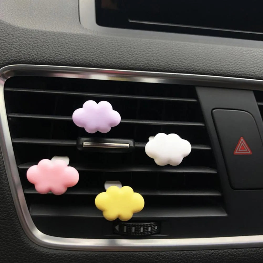 Resin cartoon car fragrance clip in one of six colours attached to vehicle air vent