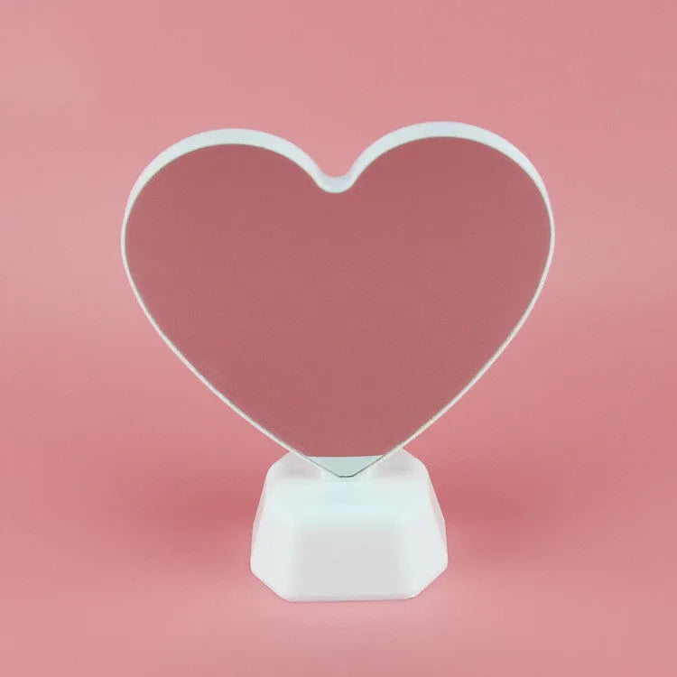 Plastic double-sided LED love tunnel light with rose red illumination on a dark background.