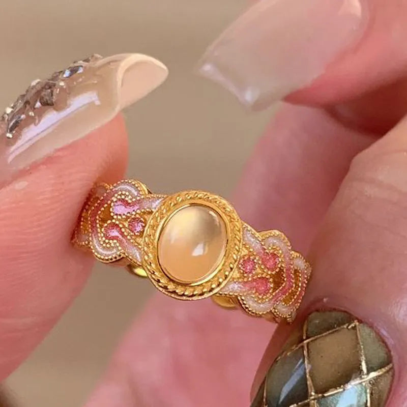 Geometric open mouth ring with pink crystal enamel detail on gold-plated copper band