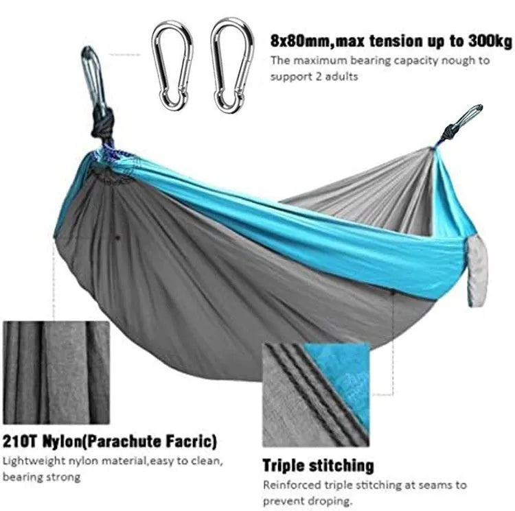 Blue parachute cloth nylon camping hammock shown hung between trees.