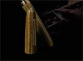 Wooden fountain pen with a rotating cap shown alongside nib options on a desk.