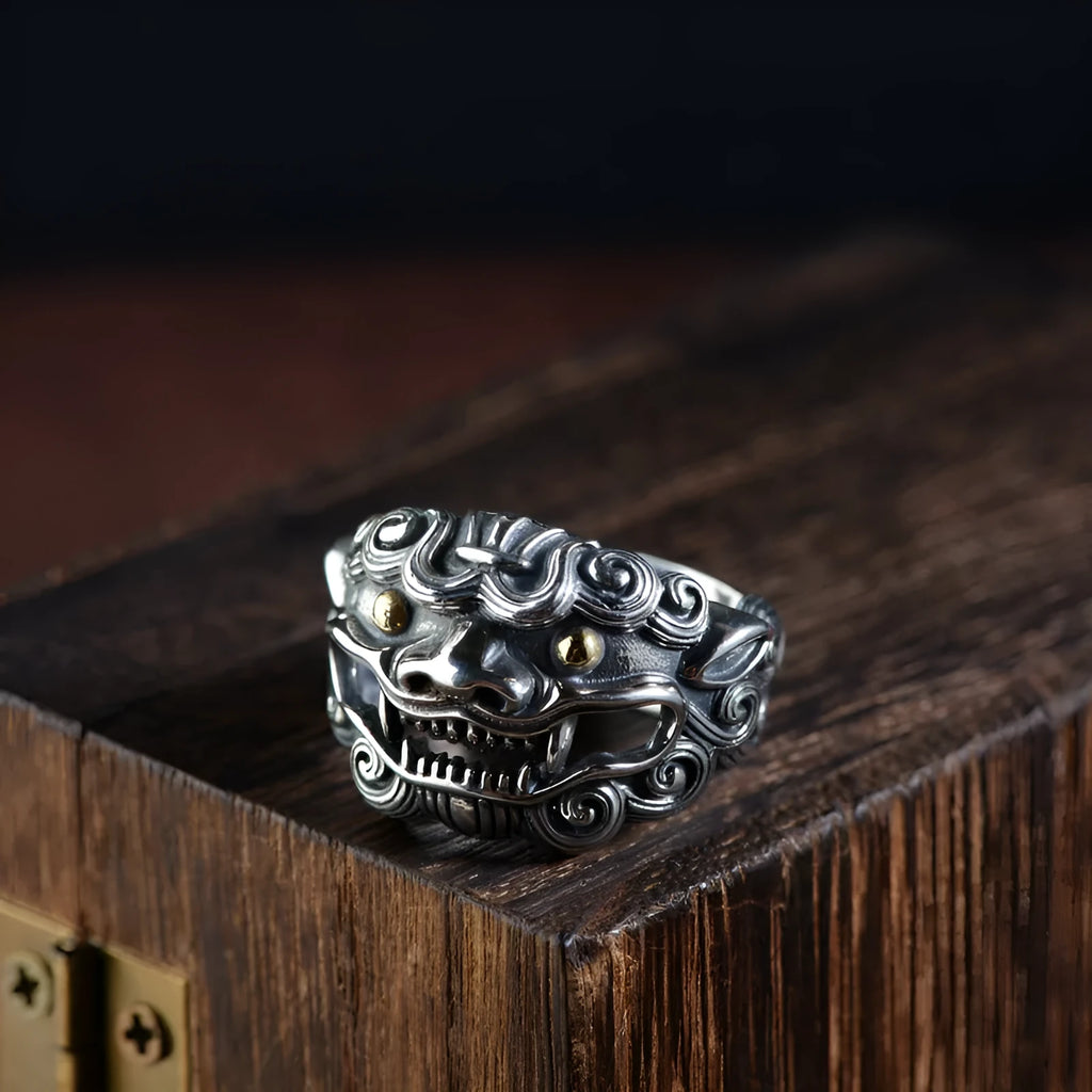 Silver open-style ring with detailed domineering jibeast animal pattern and diamond accents