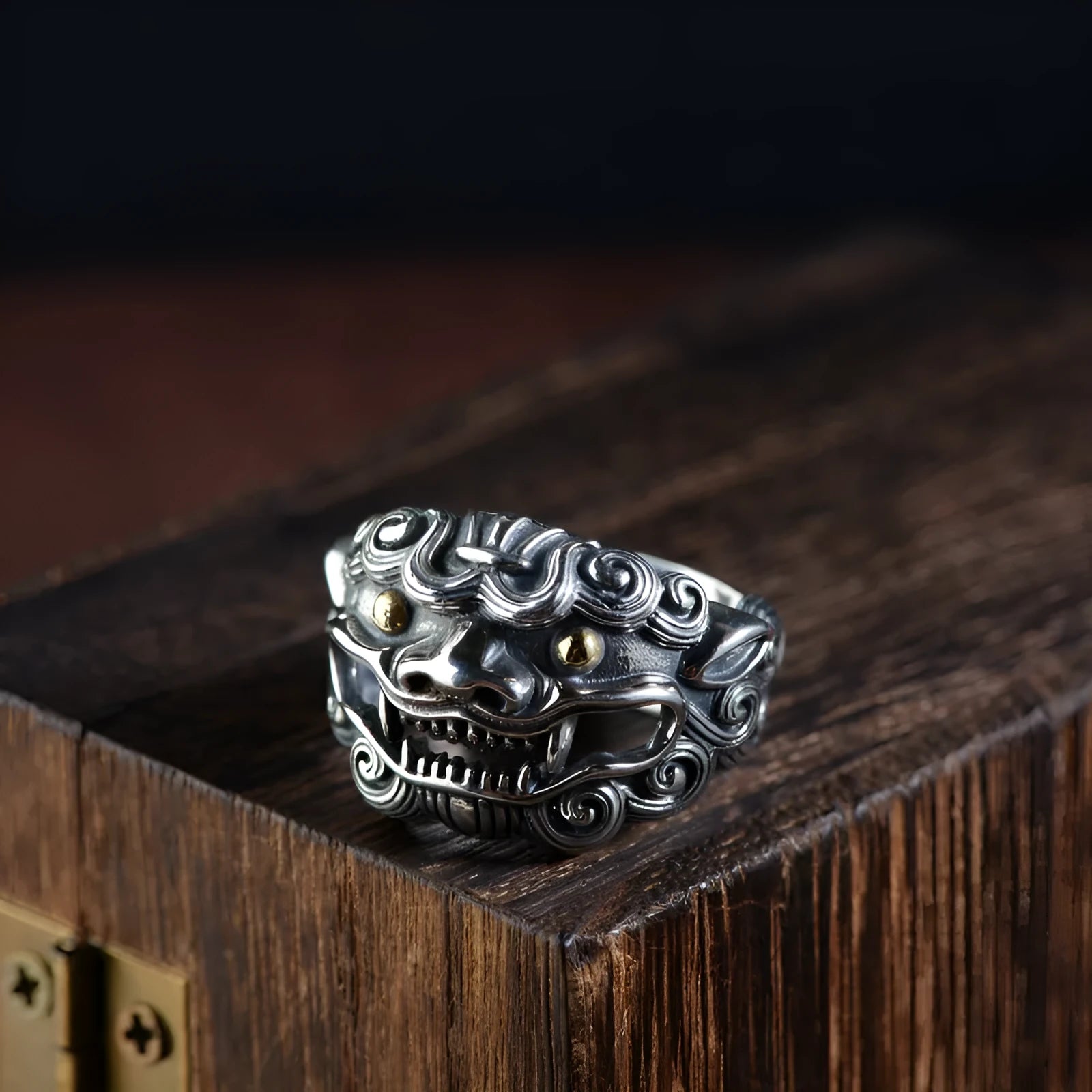 Silver open-style ring with detailed domineering jibeast animal pattern and diamond accents