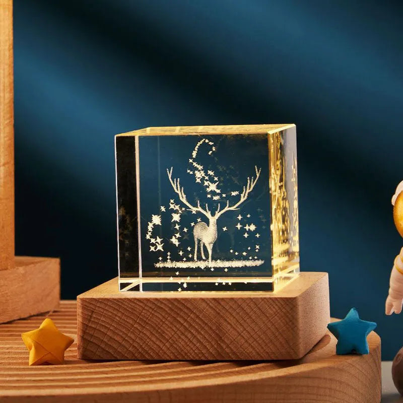 3D transparent crystal cube night lamp with warm light pattern on wooden desktop