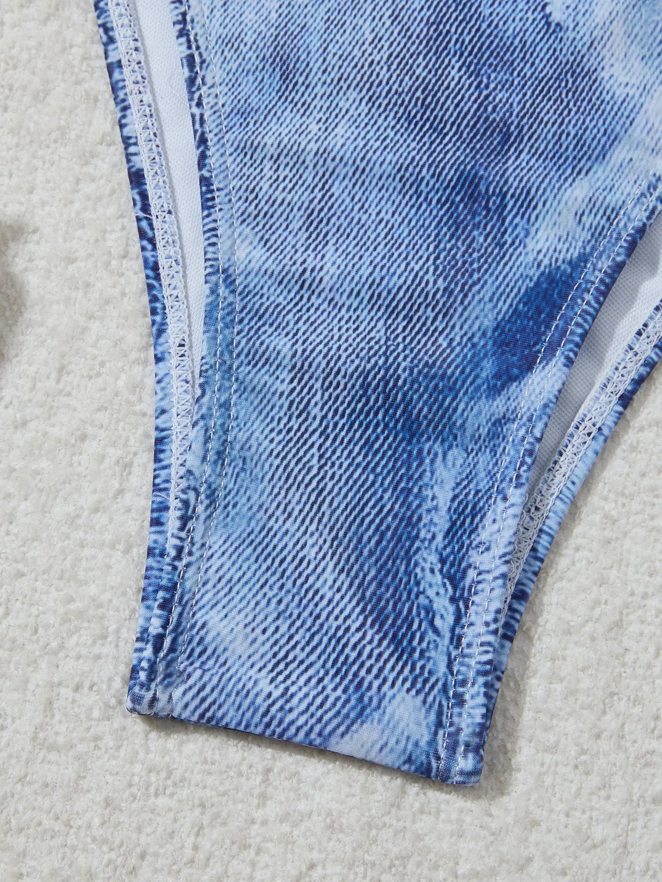 Denim blue printed women's bikini set with strappy triangle top and matching bottoms on a neutral background.
