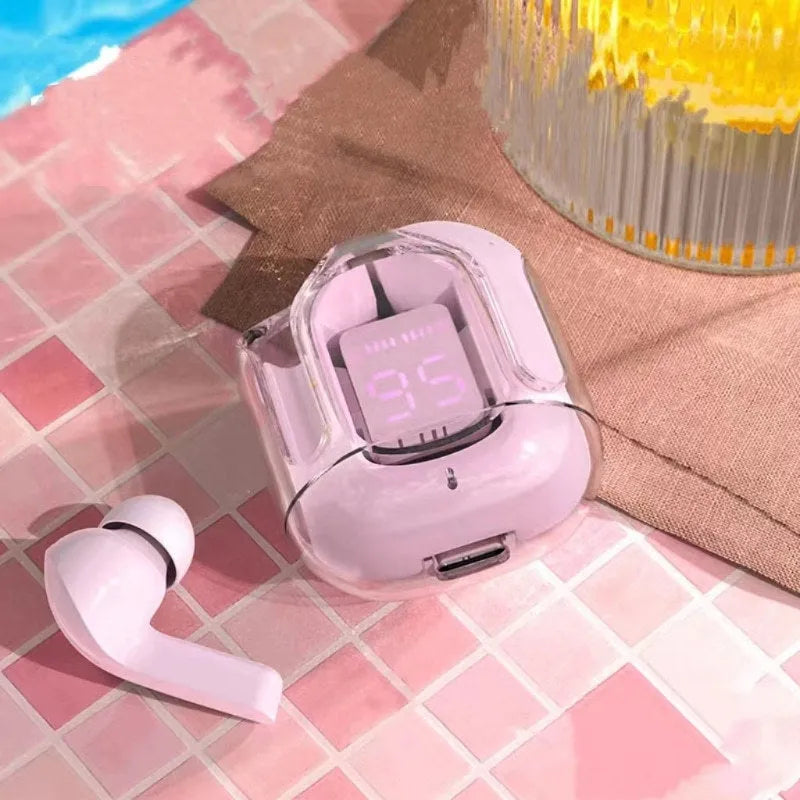 Transparent space capsule case containing black Bluetooth earphones with a digital battery display screen.