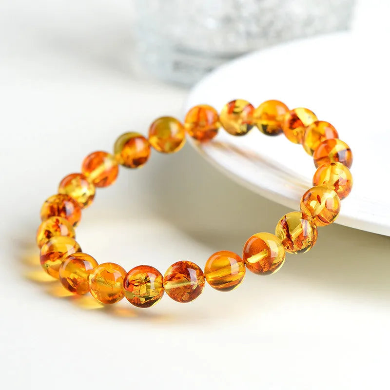 Natural yellow piebald amber bracelet with geometric beads and polished finish