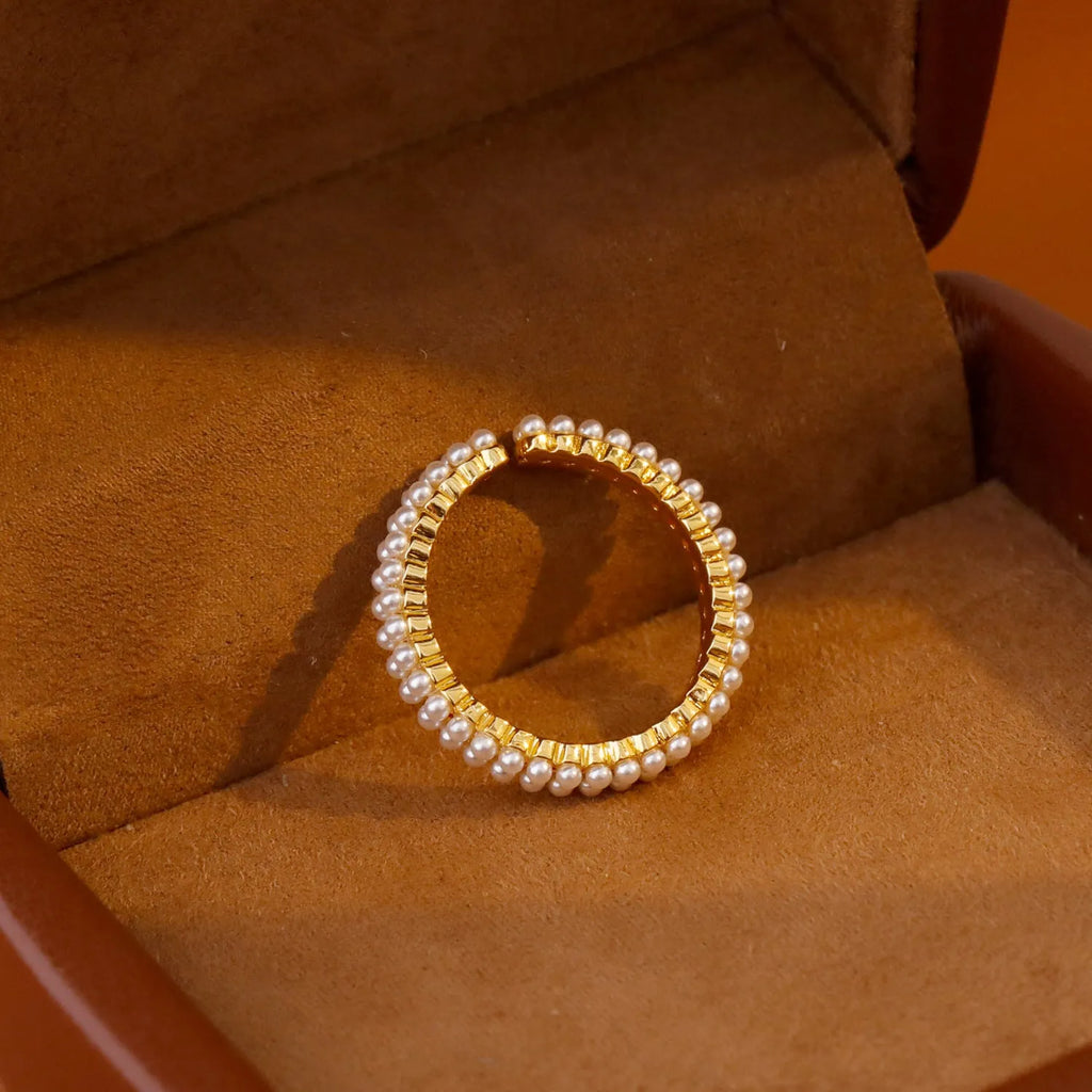 Gold geometric open mouth ring with pearl detail on female hand