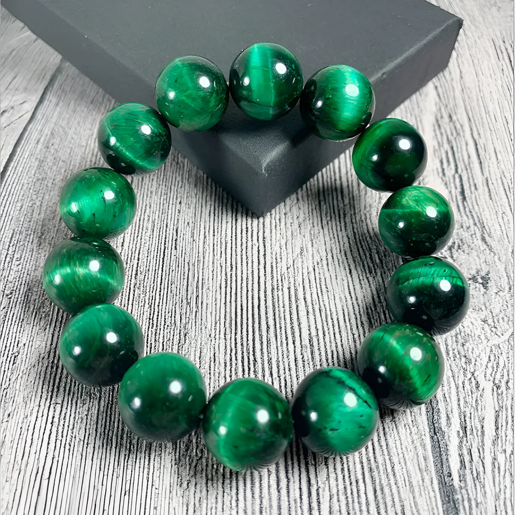 Green tiger eye stone bracelet with geometric polished beads showing banded natural patterns